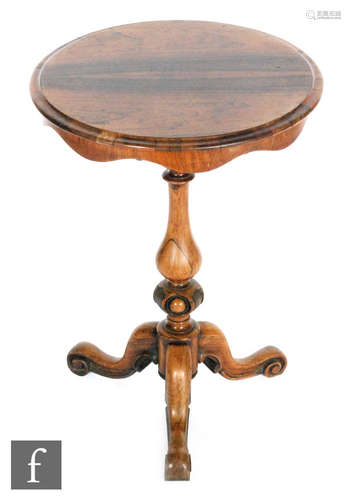 A 19th Century rosewood circular occasional table, the shaped apron above a baluster pedestal on