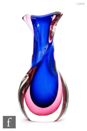 A post war sommerso glass vase of wrythen form, the blue core cased in purple cased in clear, height