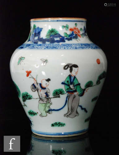 A Chinese porcelain wucai glazed 'Boys at play' vase, of meiping form, rising to a brown glazed rim,