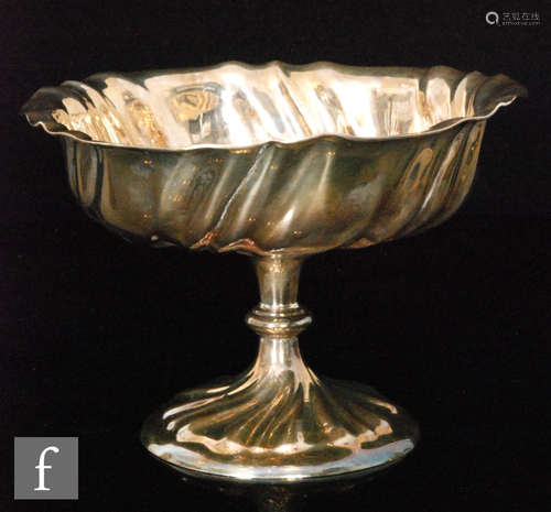 An early 20th Century hallmarked silver pedestal bowl of wrythen fluted form, height 14cm,