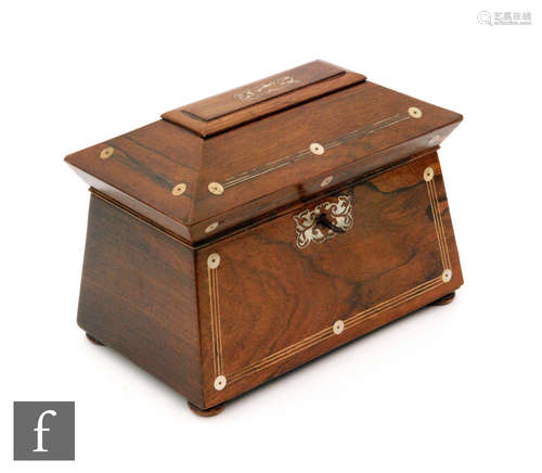 A 19th Century rosewood tea caddy of sarcophagus form with compressed bun feet, two divisions to