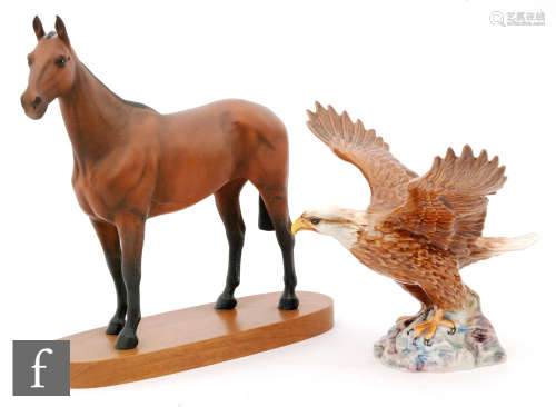 A Beswick model of Arkle, model 2065 from the Connoisseur Horses series, raised to an oval plinth,