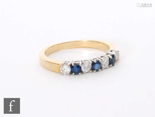 A 18ct hallmarked sapphire and diamond half eternity ring, seven alternating claw set stones to