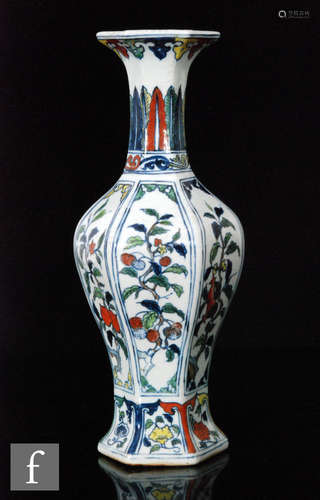 A Chinese Jiajing style vase hexagonal baluster vase, rising from a splayed base and extending to