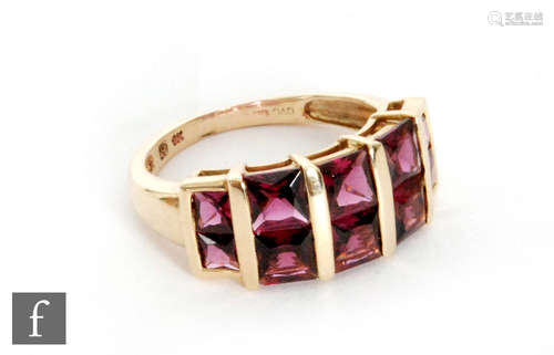 A 9ct hallmarked almandine garnet ring, two rows of five square cut stones to tapering shoulders,