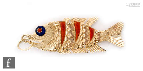 An 18ct hallmarked flexible pendant modelled as a fish, with red and blue enamelled highlights,