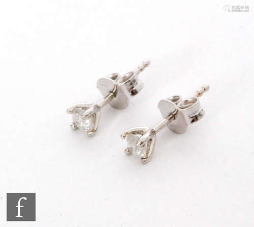 A pair of 18ct white gold brilliant cut diamond stud earring, each approximately 0.20ct, to a four