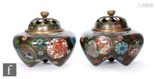 A pair of squat cloisonne censers decorated with foliate panels to a black ground below pierced