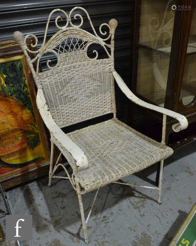 A pair of second quarter 20th Century white painted wrought iron and wicker garden armchairs with