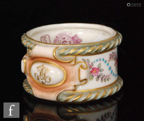 A Royal Worcester blush ivory circular napkin ring decorated with floral sprays within rope twist