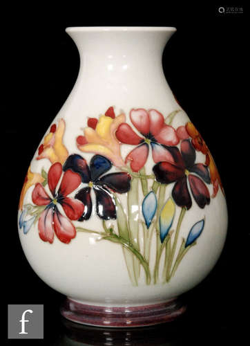 A 1940s Walter Moorcroft Spring Flowers pattern vase decorated with tubelined flowers and foliage in