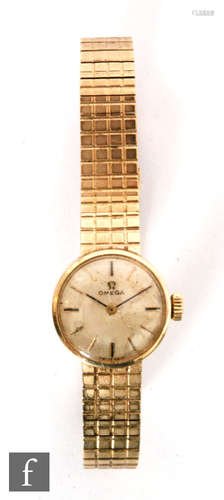 A lady's 9ct hallmarked Omega wrist watch, batons to a circular dial and brick effect bracelet,