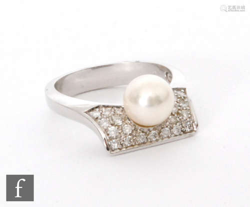 An 18ct white gold cultured pearl and diamond ring, central pearl to a pave set curved rectangular