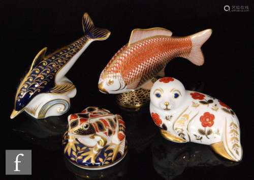 A collection of four Royal Crown Derby paperweights comprising a frog, a seal (gold stopper), a