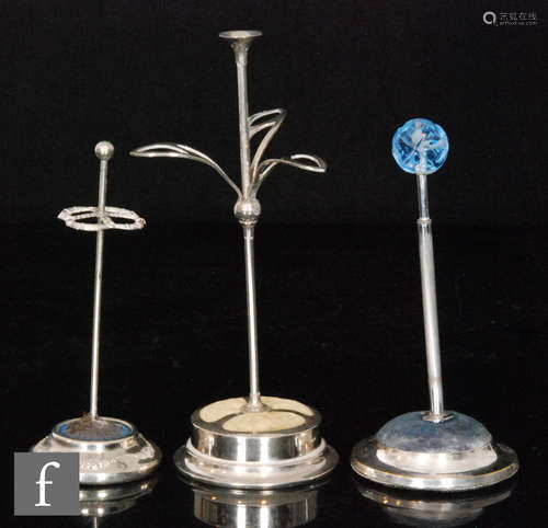 Three early 20th Century silver plated circular hat pin stands, one with stone set terminal. (3)