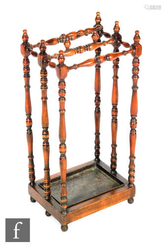 A reproduction twin section walnut stick or umbrella stand in the Victorian style, the turned