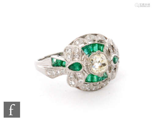 An 18ct white gold emerald and diamond ring, central old cut diamond to a cushioned rectangular