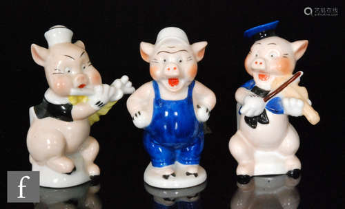 Three 1930s toothbrush holders modelled as the Three Little Pigs from the 1933 United Artists