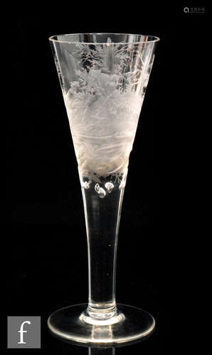 An early 20th Century oversized drinking glass in the 18th Century style, the funnel bowl engraved