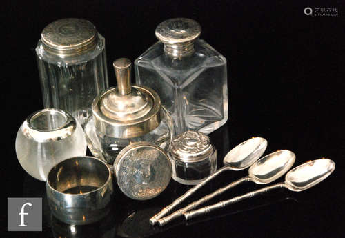 A small parcel lot of assorted hallmarked silver items to include two dressing table jars, a match