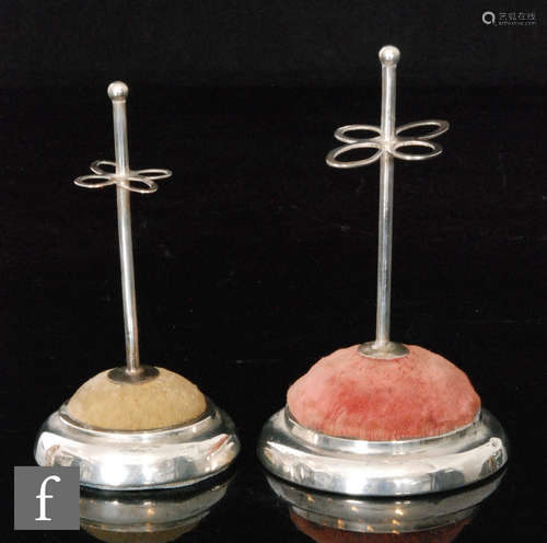 Two matched hallmarked silver hat pin stands, plain circular stepped bases encompassing cushion,