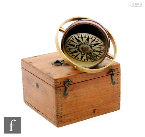 A 20th Century mahogany cased ships compass in a brass gimble frame, unnamed dial, diameter 10cm.