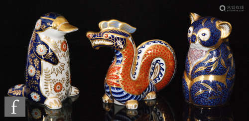 A collection of three Royal Crown Derby paperweights comprising a dragon (marked as a second), a