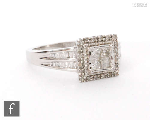 A 9ct hallmarked white gold diamond cluster ring, four square cut collar set stones to a diamond