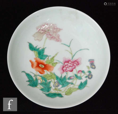 A Chinese famille rose dish of shallow circular form, the white glazed dish with central enamelled