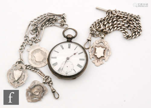 A Victorian fine silver open faced, key wind pocket watch suspended from a graduating silver