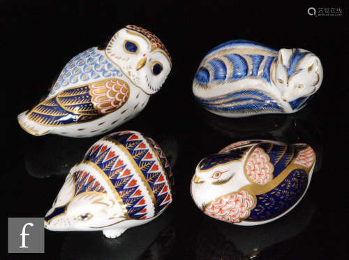 A collection of four Royal Crown Derby paperweights comprising a fox (gold stopper), a bird (gold