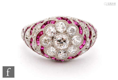 An Art Deco style 18ct white gold diamond and ruby ring, central nine stone diamond old stone