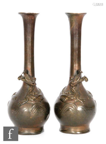 A pair of small bronze slender vases each with dragon detail, heights 16cm, unmarked.