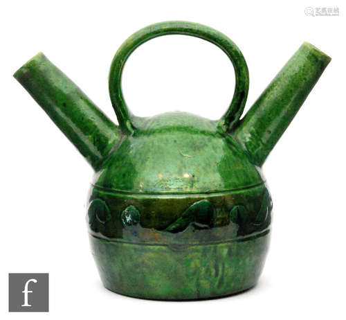 An Arts & Crafts Low Countries green glazed pottery twin necked vessel in the manner of Linthorpe