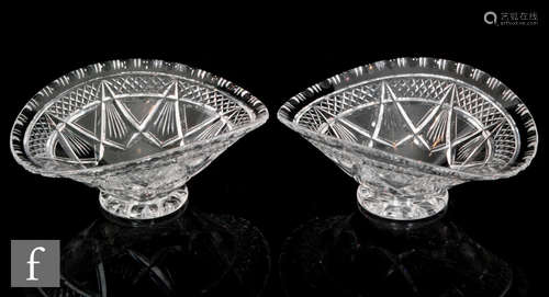 A pair of early 20th Century Stuart & Sons clear cut crystal glass bowls with a circular foot rising