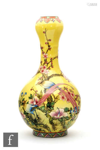 A Chinese yellow-ground vase, of bottle form standing on a high footring and terminating at a garlic