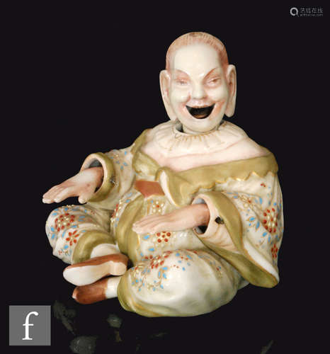 A late 19th Century German Ernst Bohne & Sohne nodding head pagoda figure in a seated position, with