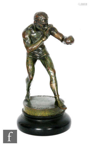 An early 20th Century bronze study of a boxer in an orthodox stance on a circular base, signed M.