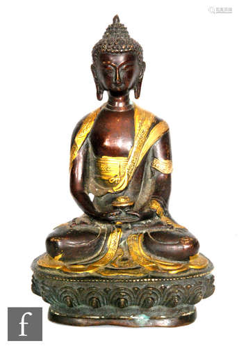 A Sino-Tibetan figure of a seated Shakyamuni Buddha, seated in quarter lotus position, eyes downcast