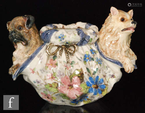 An early 20th Century bowl designed by Theodore Deck, formed as a bag with rope tie with two dogs