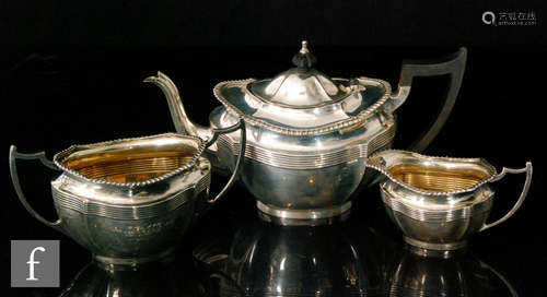 A hallmarked silver three piece boat shaped tea set detailed with a reeded frieze below gadroon