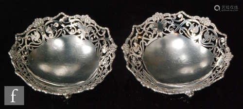 A pair of hallmarked silver pierced bonbon dishes edged with reticulated foliate decoration, each