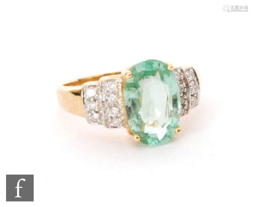 An 18ct hallmarked green tourmaline and diamond ring, central oval claw set stone to diamond set