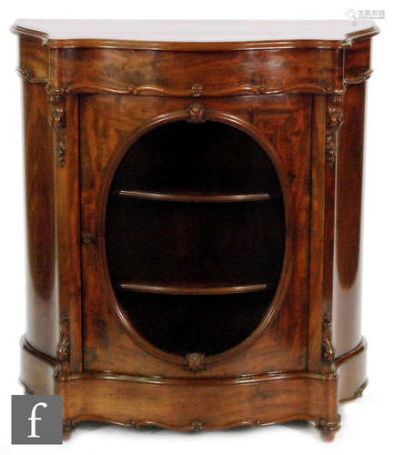 A Victorian serpentine fronted mahogany pier cabinet, with acanthus carved capitals and with an oval