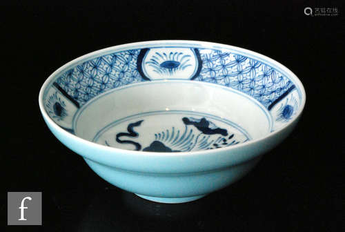 A Chinese Kangxi style blue and white bowl, the stepped and flared bowl decorated with central lotus