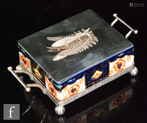 An Edwardian Imari palette sardine box with a silver plated stand and cover decorated with a