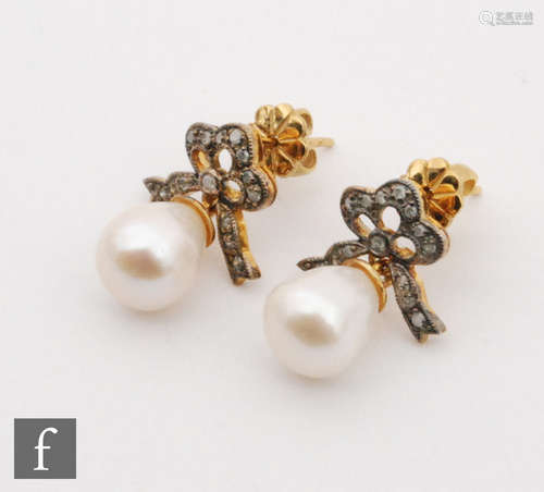 A pair of silver gilt cultured pearl and diamond drop earrings, tear shaped pearl below diamond