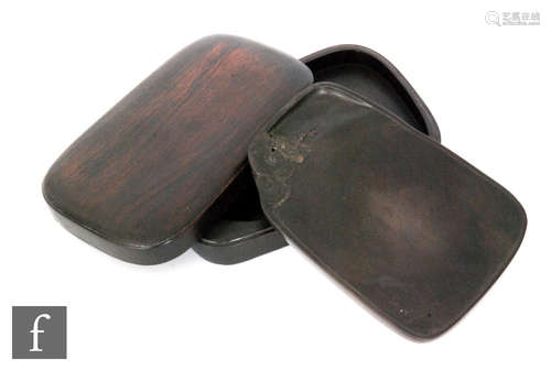 A Chinese ink block, the smooth polished stone with shallow well and adorned with carved lotus