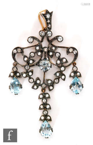 An Edwardian style silver gilt aquamarine, seed pearl and diamond set open work pendant, length 5cm,