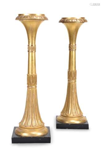 A pair of giltwood and composition torcheres in George IV style